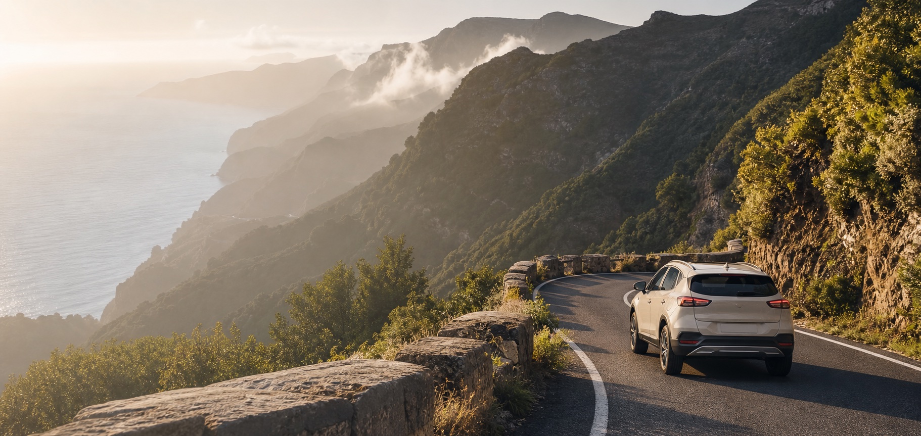 A rental car on a winding mountain road above the Atlantic coast in Madeira